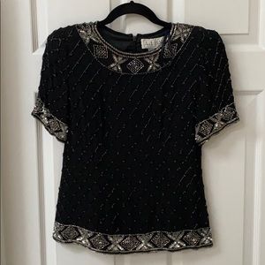 Pair this detailed top with silky pants or a skirt